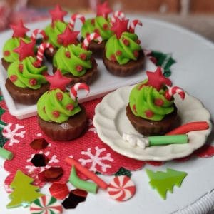 green christmas cupcakes with a candy cane